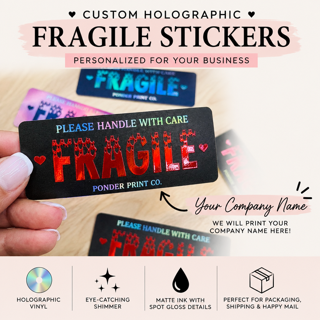 A hand holds a custom Fragile shipping sticker with a black holographic background and gloss red lettering. Red and blue text reads 'Please handle with care' and 'FRAGILE' in a splattered font, with 'Ponder Print Co.' printed below.